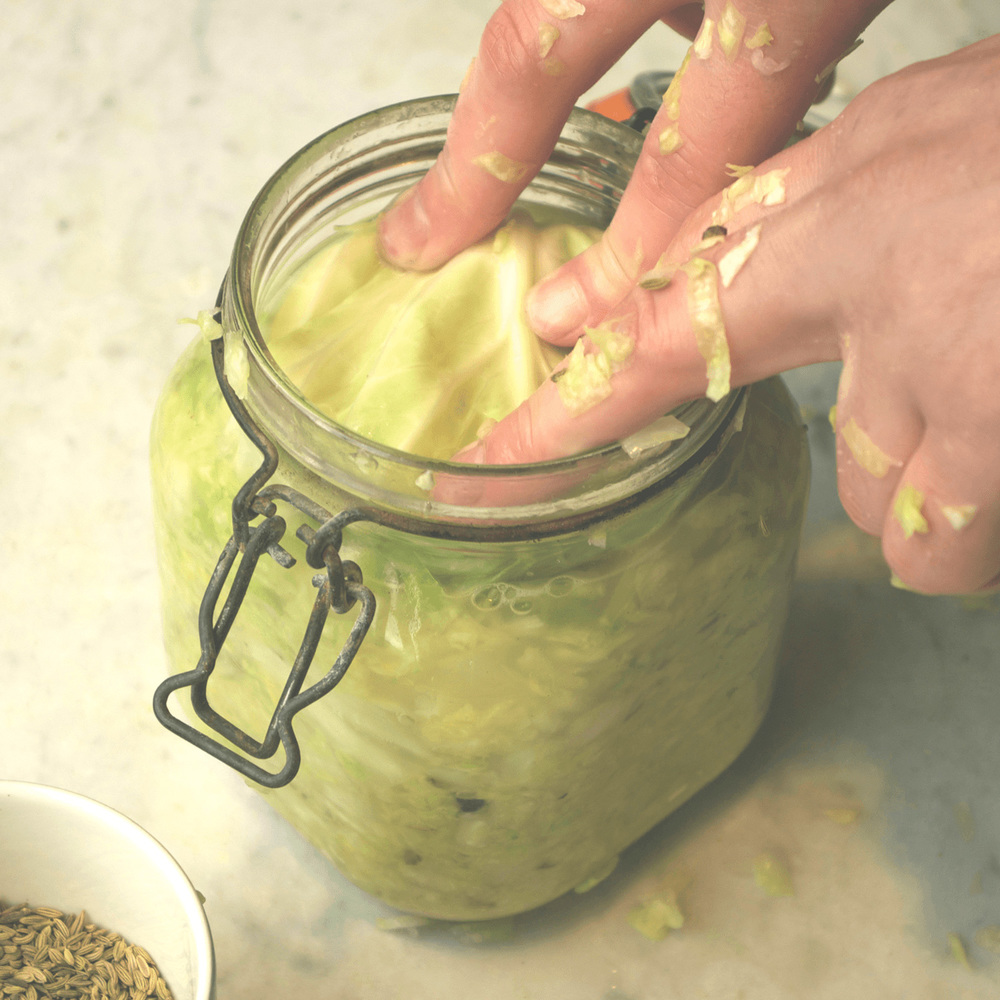 Take a clean outer leaf and fold it to a shape that fits into the mouth of your jar, press down.