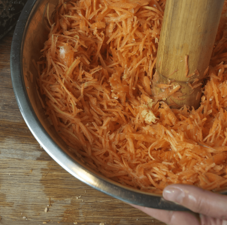 Squeeze or pound the carrots to release the juices