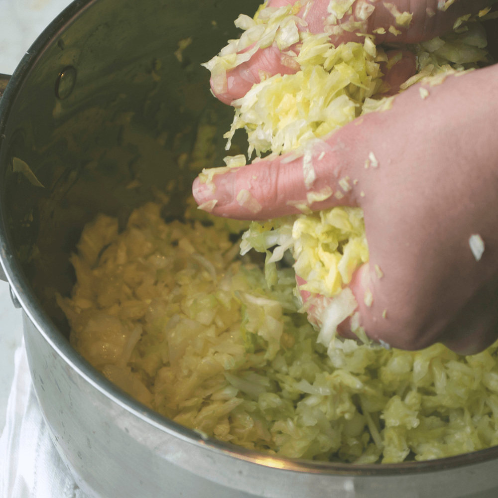 Sprinkle with two teaspoons of salt, and start rubbing and squeezing the cabbage in your hands.